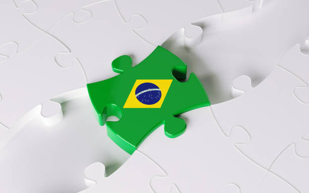 Quebra cabeça com peças brancas e uma peça ao centro destacada com as cores e formas da bandeira do brasil
