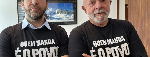Andre Janones e Lula, com uma camiseta preta que diz "quem manda é o povo"