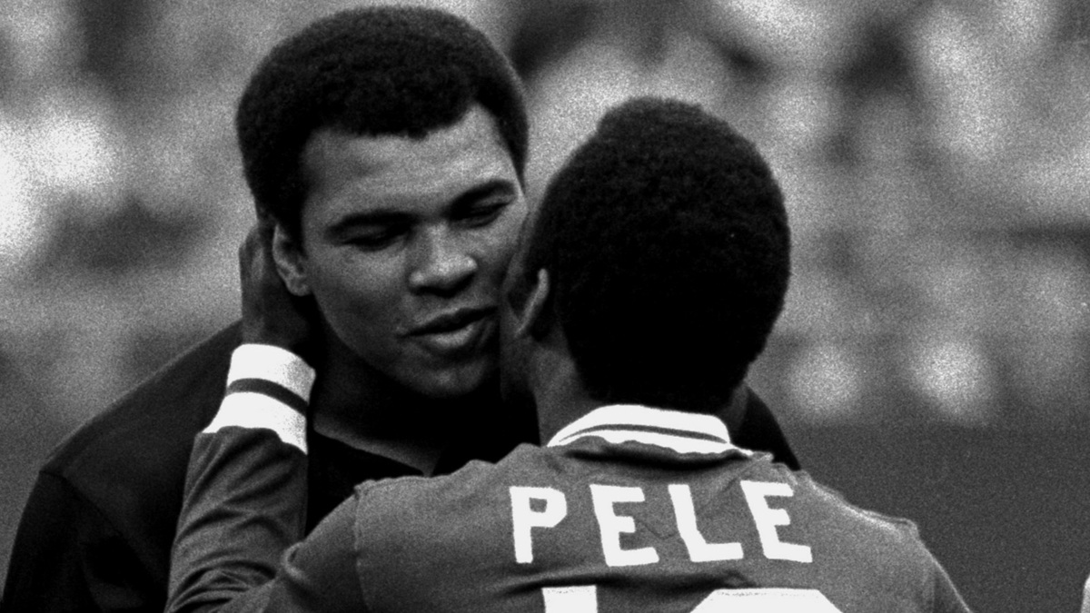 Soccer player Pele, right, embraces boxer Muhammad Ali during a ceremony honoring the Brazilian soccer star of the New York Cosmos at Giants Stadium, East Rutherford, N.J., October 1, 1977.  Cosmos won 2-1 over Santos of Brazil in the final game of Pele's career, in which he played on both sides, one each half.  (AP Photo) File written by Adobe Photoshop¨ 4.0